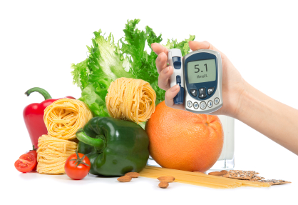 Diabetes concept glucose meter in hand fruits, vegetables